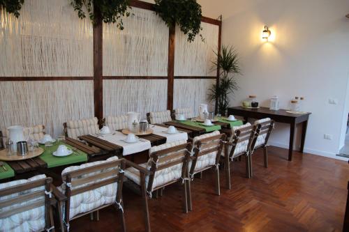 a dining room with a long table and chairs at B&B Gallidoro in Palermo
