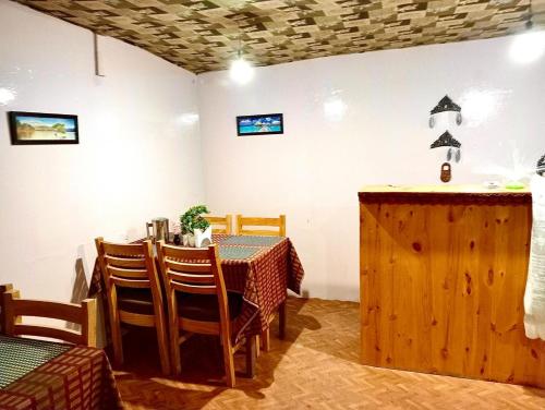 a dining room with a table and chairs at Pangong Mentsel Cottage in Lukung