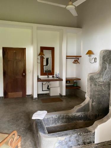 a living room with a couch and a table at Amuura Beach Villa in Beruwala