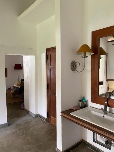 a bathroom with a sink and a mirror at Amuura Beach Villa in Beruwala
