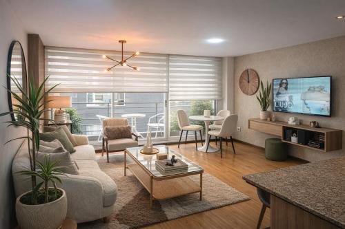 a living room with a couch and a table at Like a Home - 2Bedrooms - QueenBed - Balcony - Parking - 7Th FLOOR in Quito