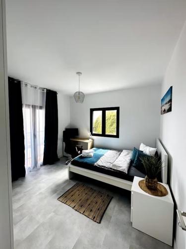a bedroom with a bed and a desk in it at CoLiving Funchal in Funchal
