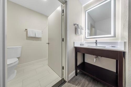 a bathroom with a sink and a toilet and a mirror at Comfort Inn & Suites Mt Laurel-Philadelphia in Mount Laurel