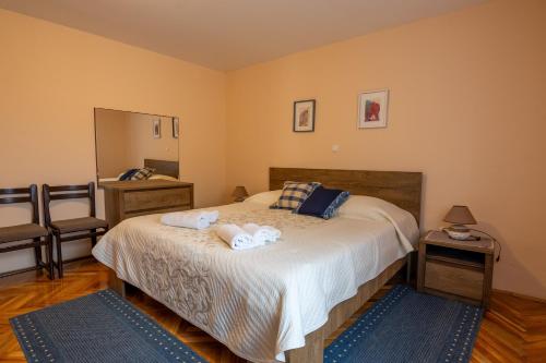 a bedroom with a bed with towels on it at Apartment Marta in Ražanac