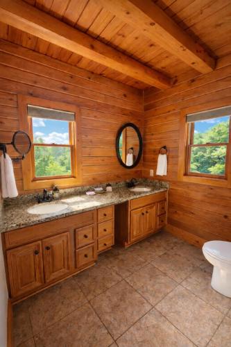 a bathroom with a sink and a mirror in a cabin at Wilderness retreat in Marion