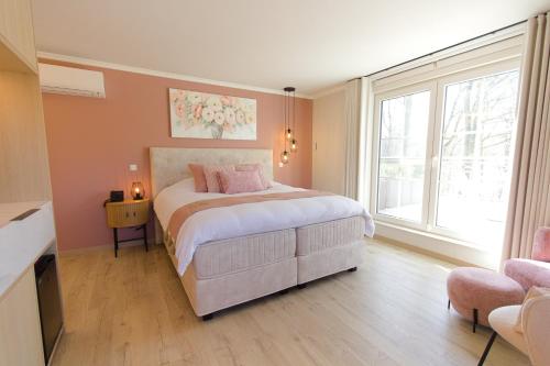 a bedroom with a bed and a large window at Bed and Breakfast L'Orée Du Bois in Wavre