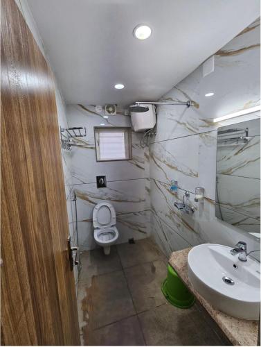 a bathroom with a toilet and a sink at V3 Inn Private Limited in kolkata