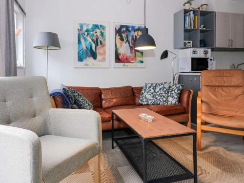 a living room with a couch and a table at 6 person holiday home in Hadsund in Hadsund