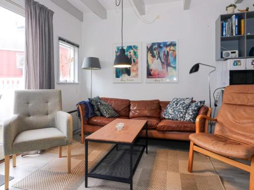a living room with a couch and two chairs at 6 person holiday home in Hadsund in Hadsund