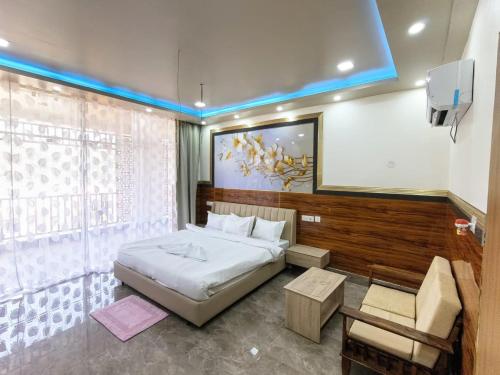 a bedroom with a bed and a tv in it at Ankush Resort in Vishnupur