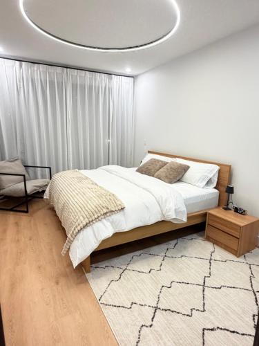 a bedroom with a bed and a circular ceiling at Downtown Luxe Stay - High River in High River