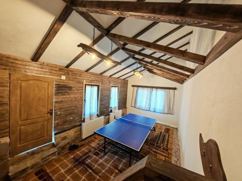 a ping pong table in the middle of a room at Casa Piatra Corbului in Gura Teghii