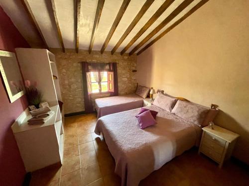 a small bedroom with a bed and a window at Bed Breakfast - Casa Rural in Úbeda