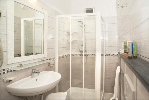 a white bathroom with a sink and a shower at Stella Della Marina in Monterosso al Mare