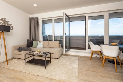 a living room with a couch and a table at Ostsee Suite 3 - Strandperle in Niendorf