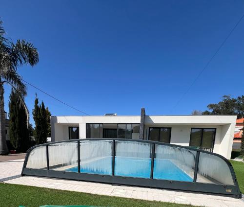 a house with a swimming pool in front of it at Meirinha House in Viana do Castelo