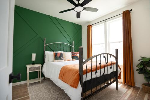 a bedroom with a green wall and a bed at Windbird Mountain Retreat STR-300 in Buena Vista