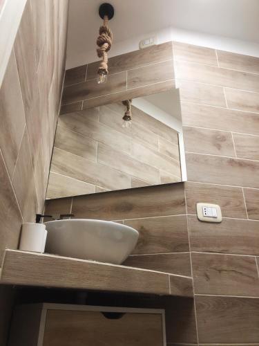a bathroom with a sink and a mirror at B&B Santa Chiara Home in Caserta