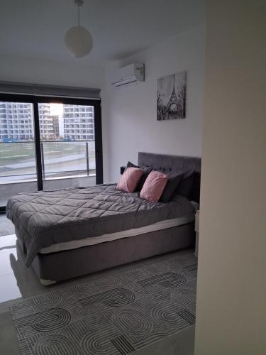 a bedroom with a large bed with pink pillows at Fabius 12 Caesars Resort & Spa in Iskele