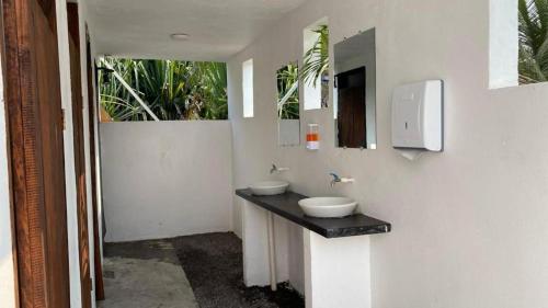a bathroom with two sinks and a mirror at Hot Chipilin El Paredon in Sipacate