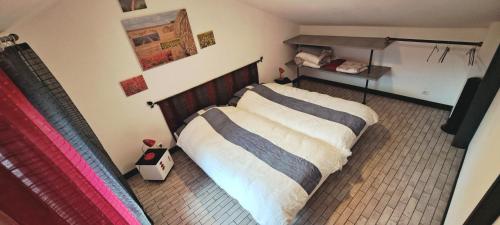 a bedroom with a bed with a wooden headboard at Le Chalet des Côtes in Cornimont
