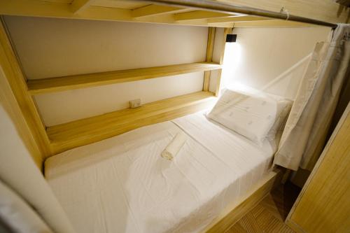 an overhead view of a bed in a small room at SunDay Hostel in Siquijor