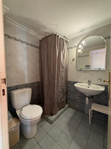 a bathroom with a toilet and a sink at Cavo D' Oro in Piraeus