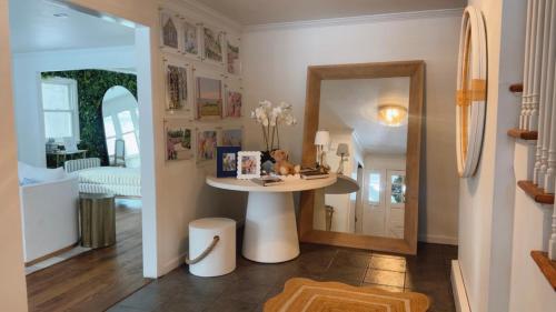 a small table in a room with a mirror at Villa Après Sea in Westport
