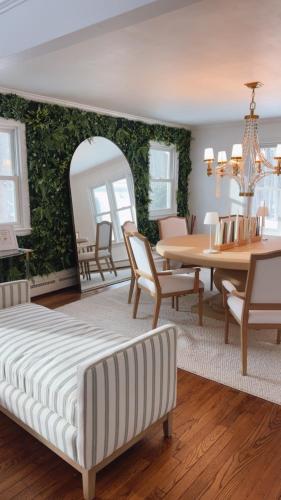a living room with a table and a dining room at Villa Après Sea in Westport