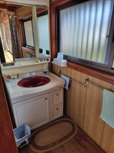 a bathroom with a sink and a mirror at 玉の浦sea in Nachikatsuura