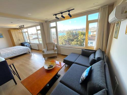 a living room with a couch and a large window at Kuzguncuk View in Istanbul