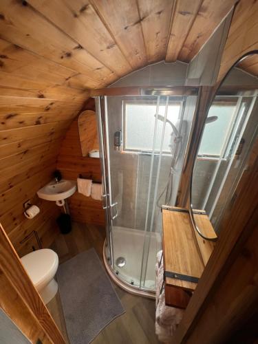 a bathroom with a shower in a cabin at Smugglers Cove in Widows Row
