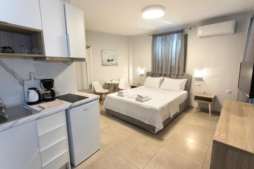 a hotel room with a bed and a kitchen at ANAX APARTMENTS PARGA in Parga