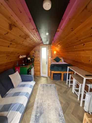 a room in a log cabin with a couch and a table at Smugglers Cove in Widows Row