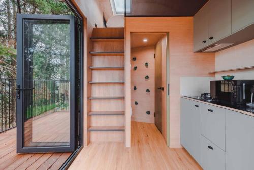 a kitchen with a spiral staircase in a house at Tiny family getaway - breathe in the country air in Glenquarry