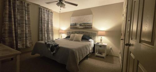 a bedroom with a bed and a ceiling fan at Old Fort Loft King & Queen suites nearest accomodation to Marshals Museum power your EV for free! in Fort Smith