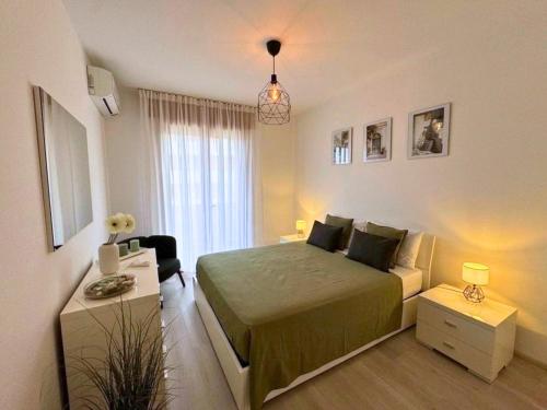 a small bedroom with a bed and a couch at Villa Manuela in Grado