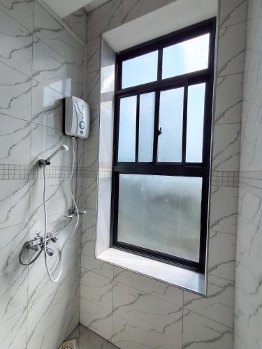 a window in a bathroom with a shower at Snow View Residences in Msaranga