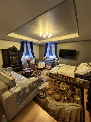 a living room with two beds and a couch at Warmiński Apartament in Biskupiec