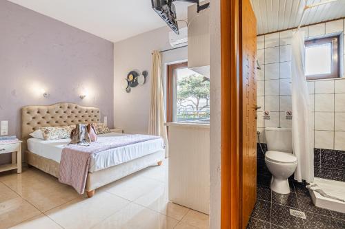 a bedroom with a bed and a tub and a toilet at Anna Studio in Amoudara Herakliou
