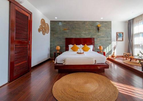 a bedroom with a large bed and a large rug at Angkor Eden Boutique Hotel in Siem Reap