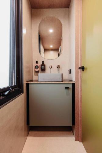 a bathroom with a sink and a mirror at Tiny family getaway - breathe in the country air in Glenquarry