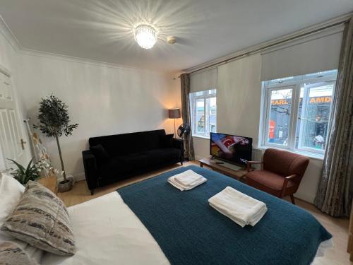 a bedroom with a large bed with two towels on it at Cosy Budget Rooms in Camden Town near Regents Park in London