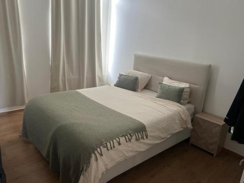 a bedroom with a large bed with two pillows at Holiday house with private jaccuzi - Leuven city center in Leuven