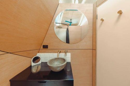a bathroom with a mirror and a bowl on a counter at Exclusive luxury tiny home in an idyllic setting in Glenquarry