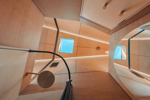 a shower in a room with a ceiling at Exclusive luxury tiny home in an idyllic setting in Glenquarry