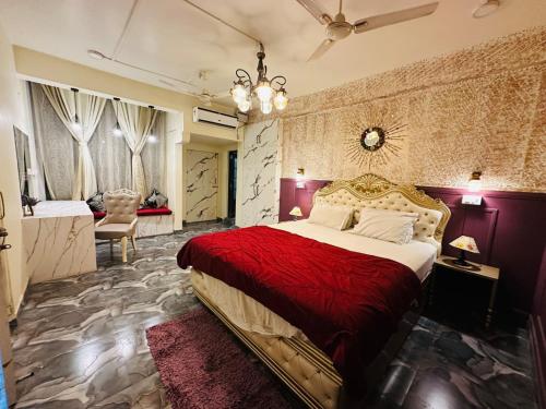 a bedroom with a large bed with a red blanket at Velouria Homestay in Guwahati