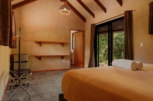 a bedroom with a large bed and a large window at Manta Project in Morrillo