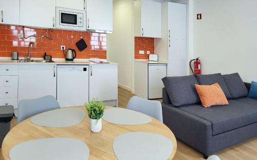 a living room with a couch and a table at Casa João de Quintal in Elvas