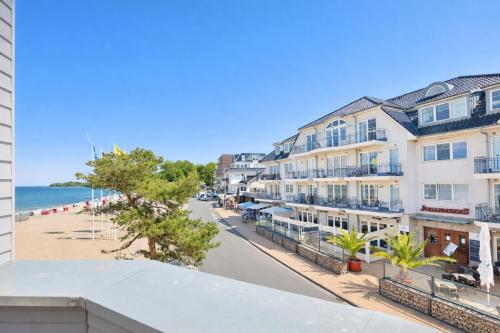 a view of the beach from the balcony of a building at Ostsee Suite 5 - Strandperle in Niendorf